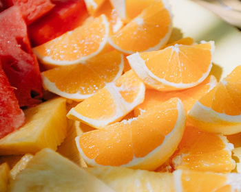 Full frame shot of fresh oranges, watermelon and pineapple slices