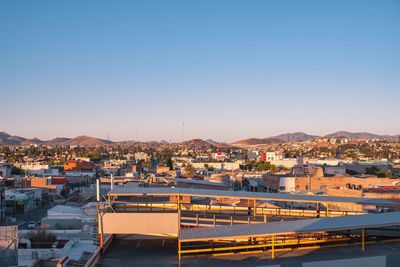 High angle view of townscape against clear blue sky