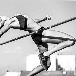 Low section of woman exercising against sky