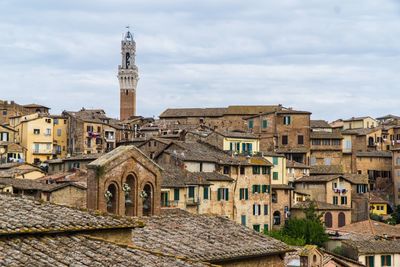 Medieval buildings in city against sky