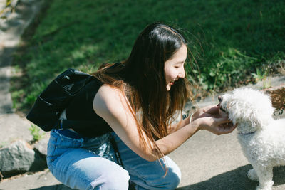 Woman playing dog on road