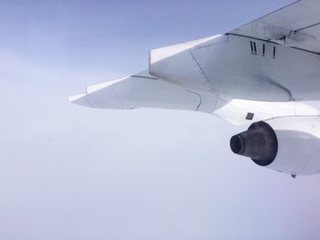 Low angle view of airplane wing against clear sky