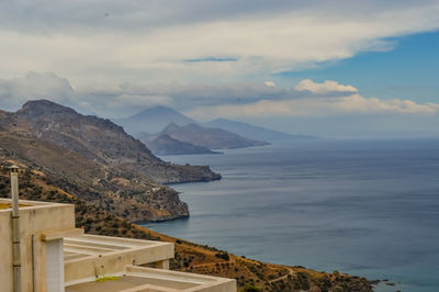 Scenic view of sea and mountains against sky