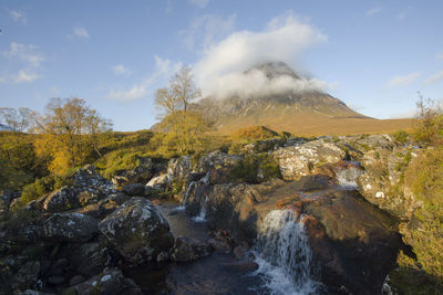 Scenic view of waterfall against sky