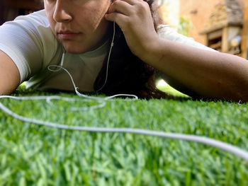 Close-up of young man lying on grass