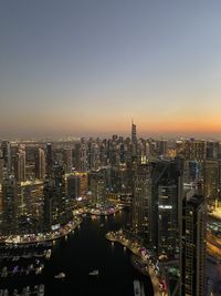 Aerial view of illuminated city against clear sky