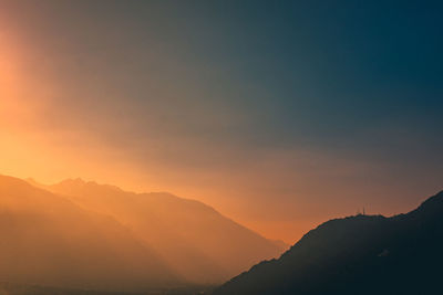 Scenic view of mountains against dramatic sky