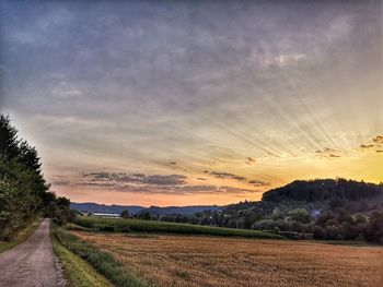 Scenic view of field against sky during sunset