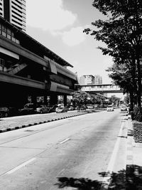 Empty road along buildings