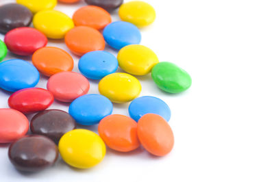 Close-up of colorful candies against white background