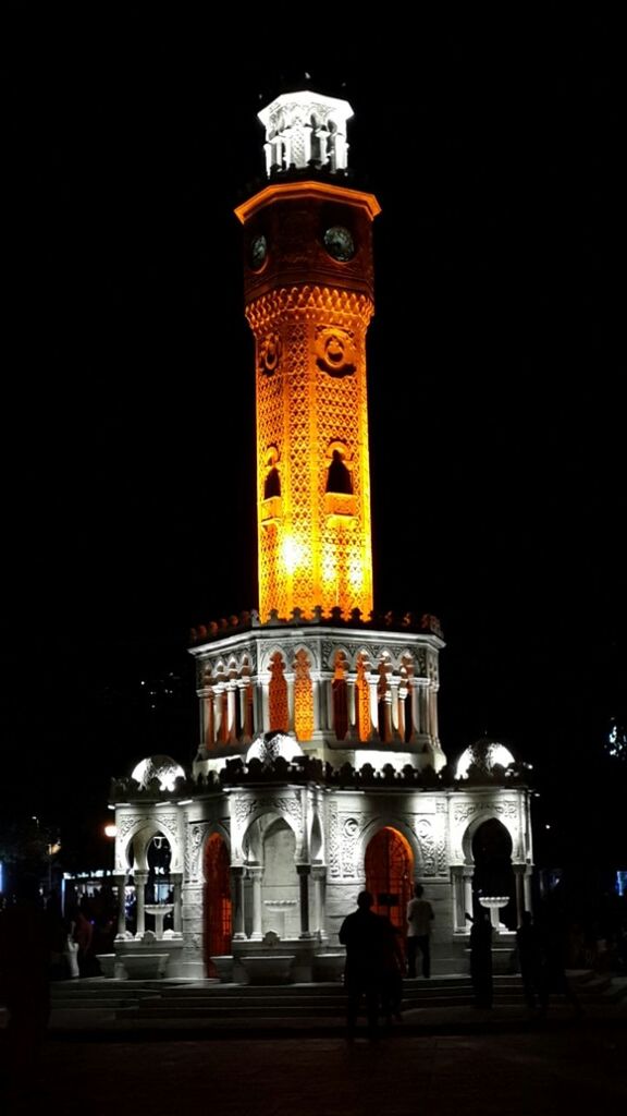 building exterior, architecture, built structure, night, illuminated, clear sky, history, travel destinations, famous place, men, facade, travel, tower, walking, city, person, tourism, street, lifestyles