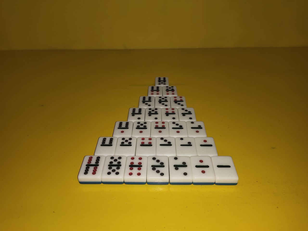 HIGH ANGLE VIEW OF PIANO ON TABLE AGAINST YELLOW BACKGROUND