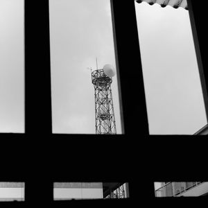 Low angle view of silhouette tower against sky