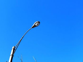 Low angle view of street light against clear blue sky