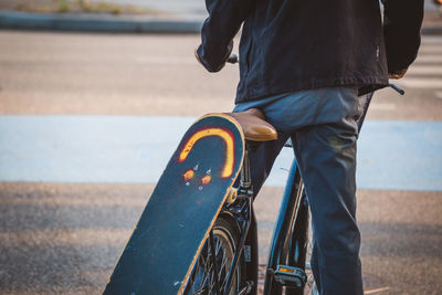 Low section of man with umbrella on road