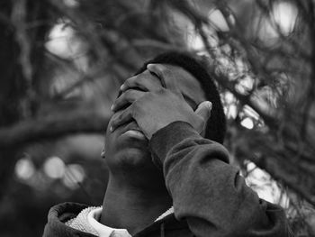 Close-up of father with hand against trees