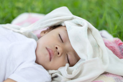 Close-up of baby sleeping on bed