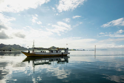 Boat moored in sea against sky