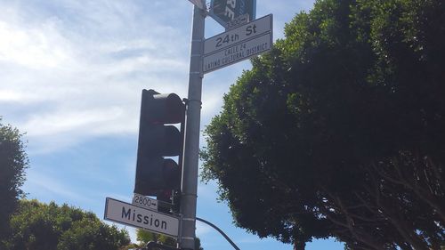 Low angle view of road signs against sky