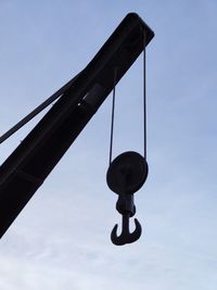 Low angle view of crane against sky