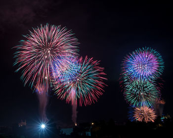 Low angle view of firework display at night