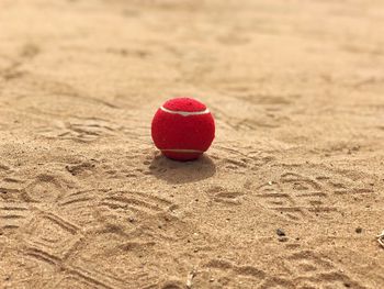 Close-up of red ball on sand