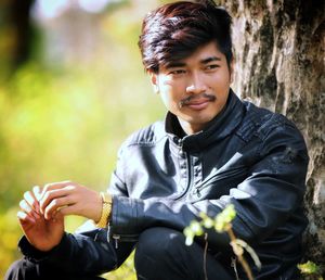 Portrait of young man sitting outdoors