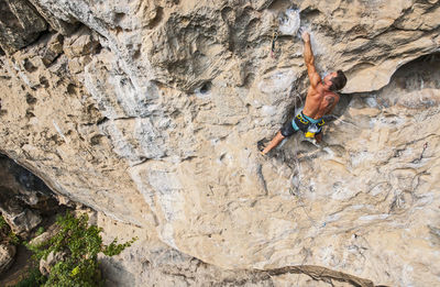 Man climbing rock face in yangshuo / china