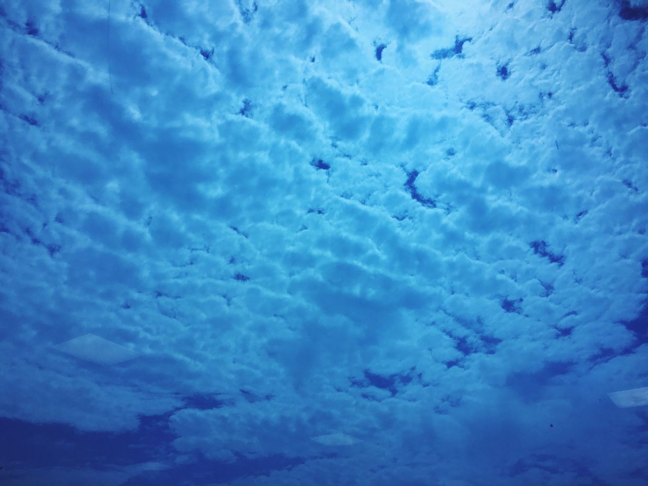 blue, cloud - sky, sky, beauty in nature, tranquility, scenics, nature, tranquil scene, weather, low angle view, cloudy, backgrounds, full frame, sky only, cloud, idyllic, cloudscape, white color, outdoors, cold temperature