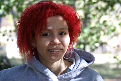 Close-up portrait of young woman with dyed hair