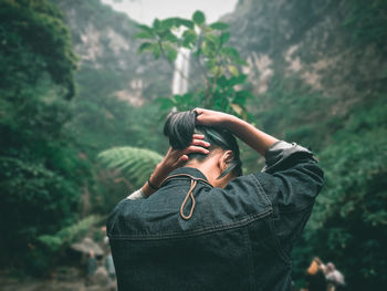 Portrait of woman standing in forest