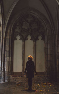 Rear view of man standing in corridor