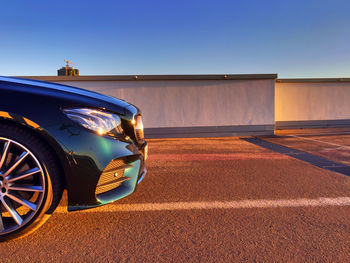 Car on road against clear blue sky