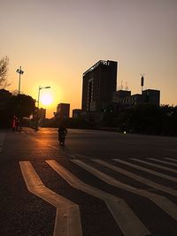 Road in city at sunset