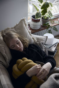 Teenage girl sleeping on sofa