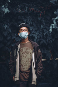 Portrait of young man standing outdoors during pandemic