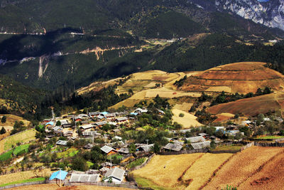 High angle view of houses in town against sky