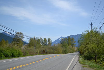 Empty road against cloudy sky