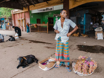 Full length of man standing with dog