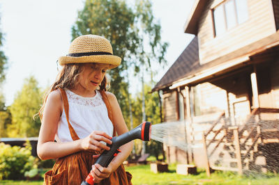 Girl holding garden hose