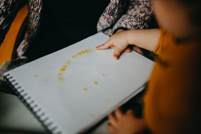 Child painting with finger