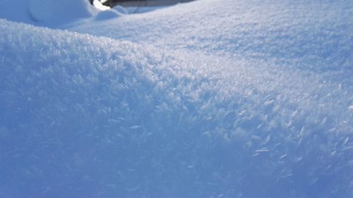 Close-up of snow on blue sky