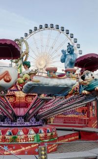 Low angle view of carousel against sky