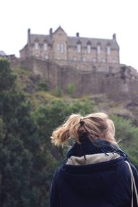 Rear view of woman looking at camera