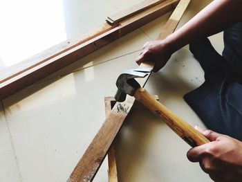 High angle view of man holding hammer