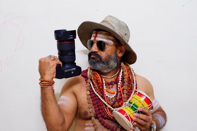 Midsection of man using mobile phone against white background