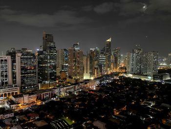 High angle view of illuminated city buildings against sky