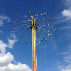 Low angle view of amusement park ride against sky