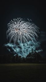 Low angle view of firework display at night