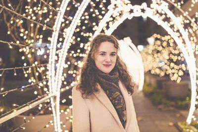 Young woman outdoors, christmas lights in the background